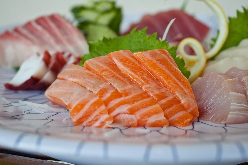 Japanese appetizers served beside a small dipping bowl.